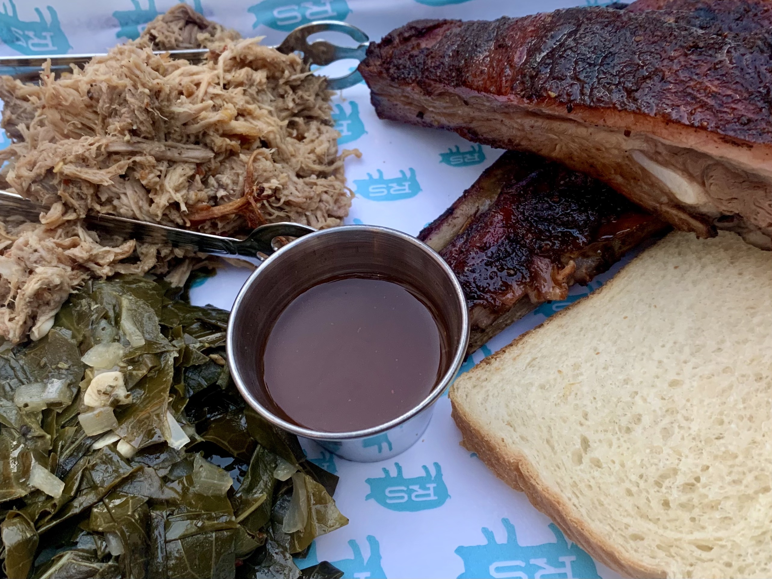Pulled pork, ribs, collard greens and white bread